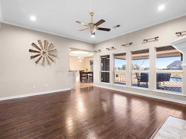 unfurnished living room featuring crown molding, dark wood-type flooring, and ceiling fan with notable chandelier