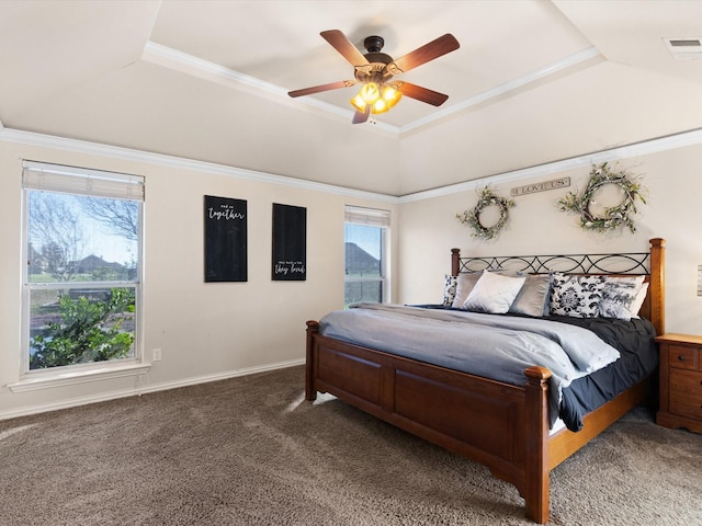 carpeted bedroom featuring a tray ceiling, ceiling fan, and crown molding