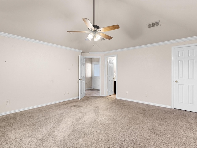 unfurnished room with ornamental molding, vaulted ceiling, and light colored carpet