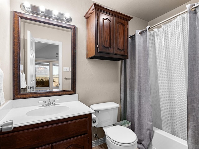 full bathroom with vanity, shower / tub combo, and toilet