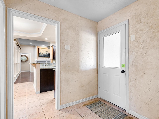 interior space featuring sink, light tile patterned floors, and ornamental molding