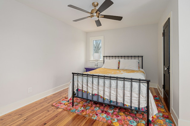 bedroom with hardwood / wood-style floors and ceiling fan