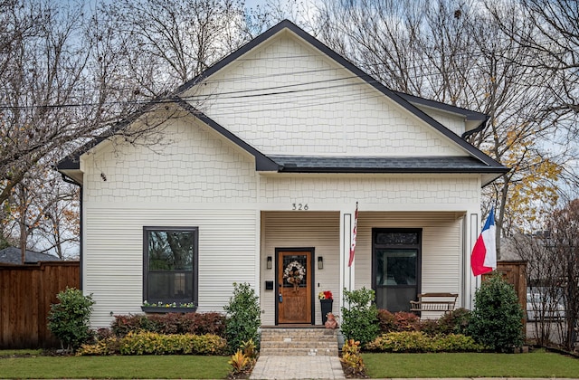 view of front of home featuring covered porch and a front lawn