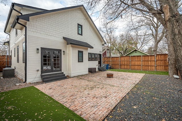 rear view of house featuring french doors, a patio, and central AC unit