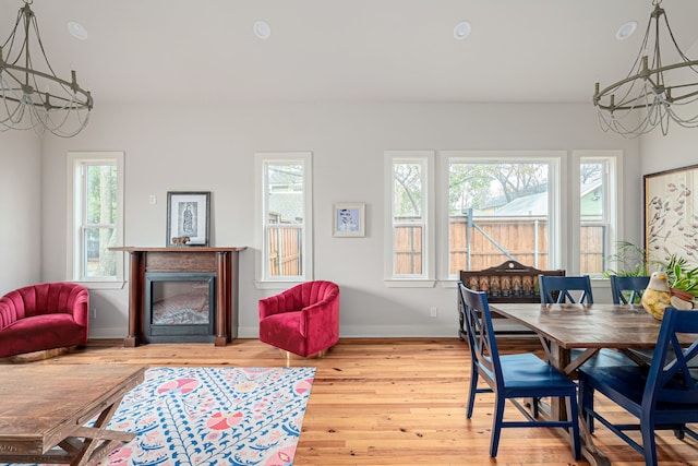 dining room with hardwood / wood-style floors and a notable chandelier