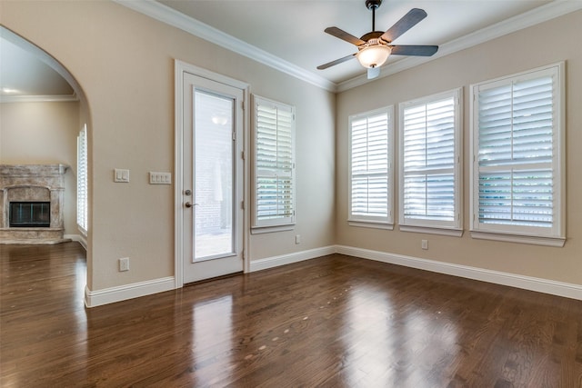 unfurnished room with ceiling fan, dark hardwood / wood-style flooring, and ornamental molding