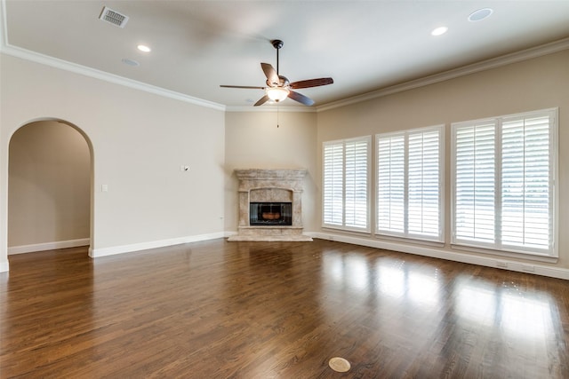 unfurnished living room with dark hardwood / wood-style flooring, a premium fireplace, crown molding, and ceiling fan