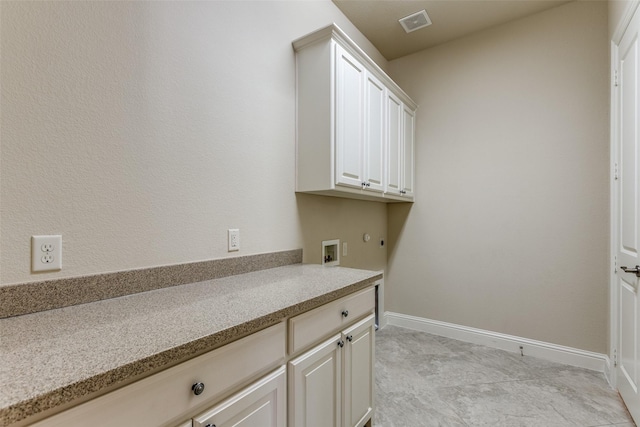 clothes washing area featuring cabinets and washer hookup