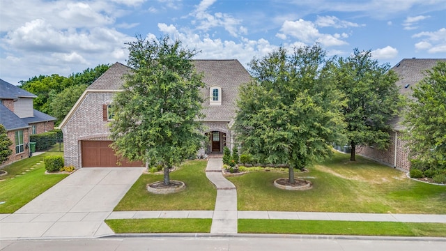 view of front of house featuring a garage and a front lawn