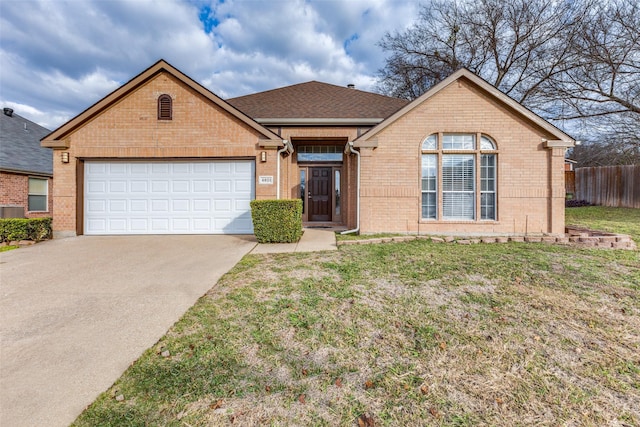 view of front of property with a garage and a front lawn