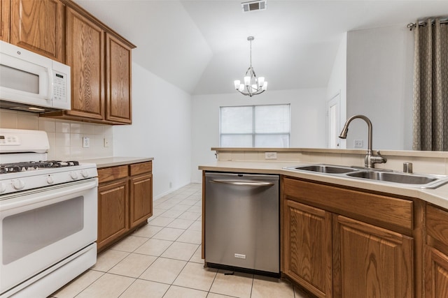 kitchen with sink, hanging light fixtures, a chandelier, lofted ceiling, and white appliances