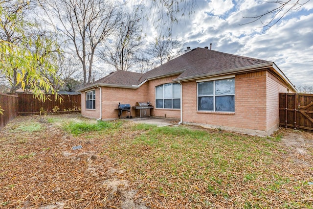 back of property featuring a yard