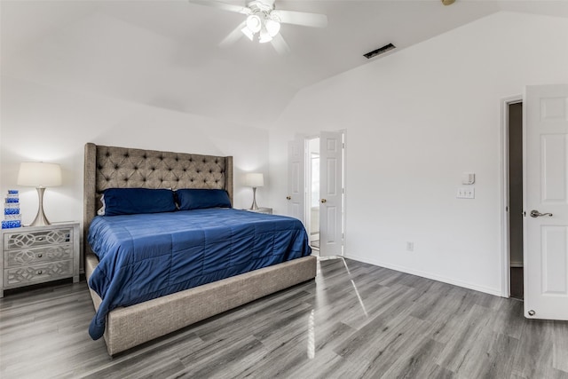 bedroom featuring ceiling fan, hardwood / wood-style floors, and lofted ceiling