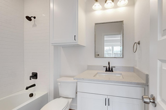 full bathroom with vanity, toilet, and tiled shower / bath