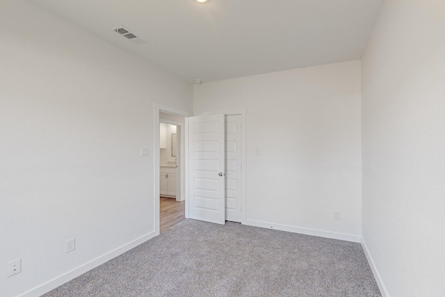 unfurnished room featuring light colored carpet