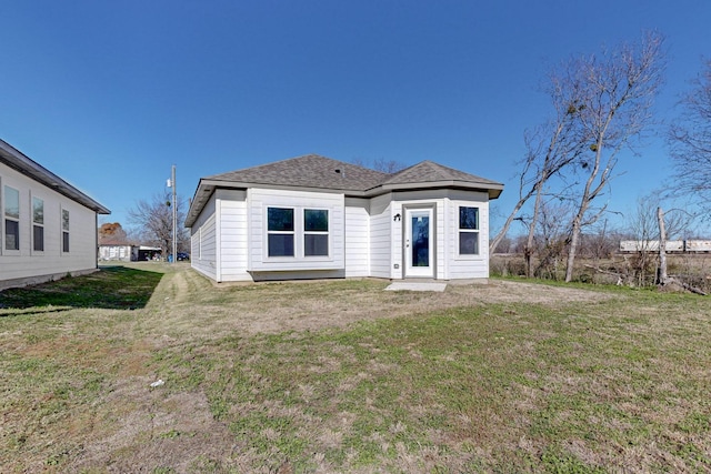 back of house featuring a yard