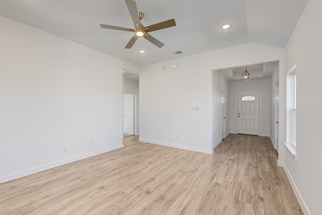 empty room with ceiling fan, lofted ceiling, and light wood-type flooring