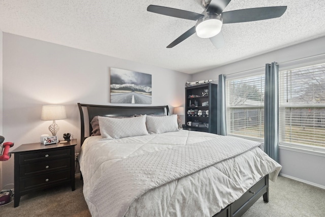 carpeted bedroom with a textured ceiling and ceiling fan