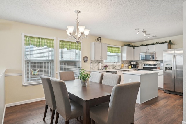 dining space with a notable chandelier, dark hardwood / wood-style flooring, and a textured ceiling