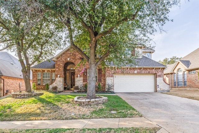 traditional-style house with a garage, stone siding, concrete driveway, and brick siding