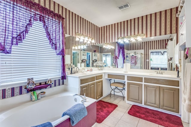 bathroom with visible vents, a garden tub, vanity, and wallpapered walls