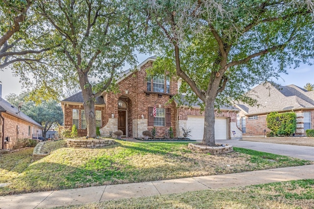 traditional-style house featuring a garage, concrete driveway, brick siding, and a front lawn