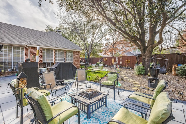 view of patio / terrace featuring a fenced backyard and a fire pit