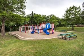 community jungle gym featuring a yard