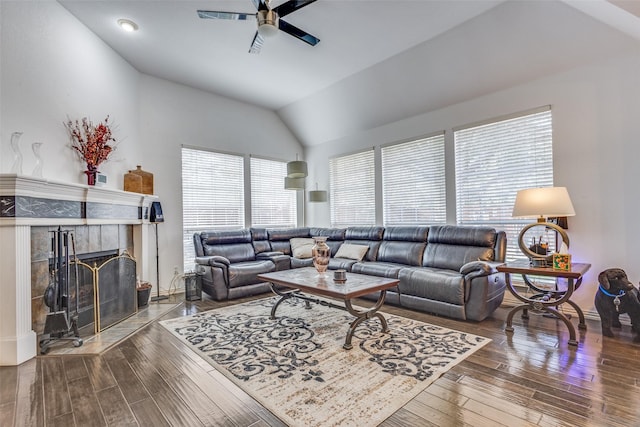 living room featuring lofted ceiling, a fireplace, ceiling fan, and wood finished floors