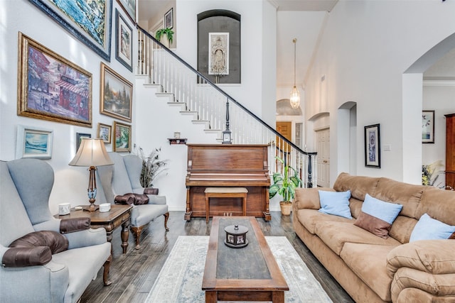 living room with wood-type flooring and a high ceiling