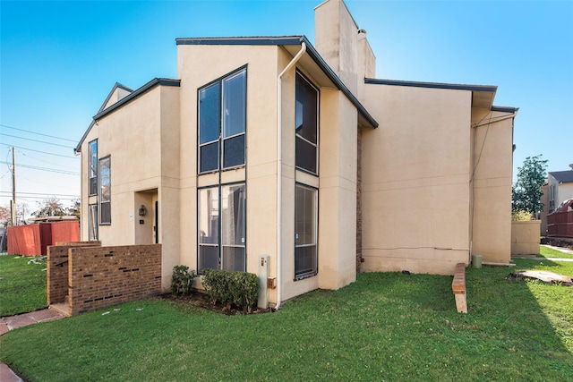 view of home's exterior with a lawn