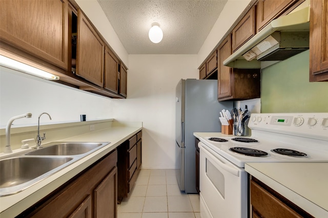 kitchen featuring white electric range, a textured ceiling, light tile patterned floors, and sink