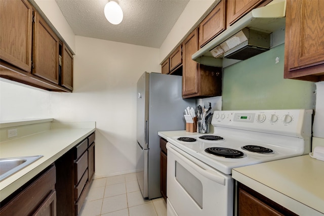 kitchen with white range with electric stovetop, light tile patterned floors, and a textured ceiling