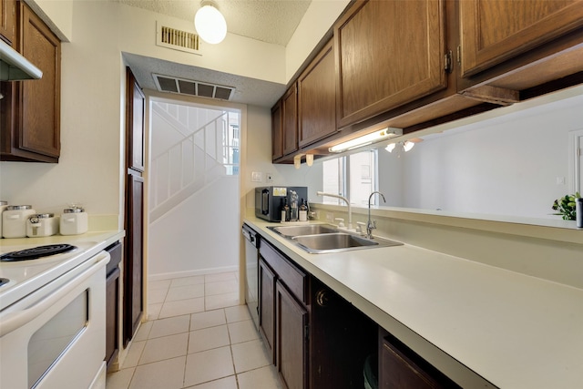 kitchen featuring white range with electric cooktop, sink, stainless steel dishwasher, a textured ceiling, and light tile patterned flooring