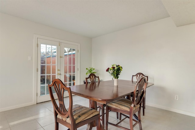 dining space featuring french doors and light tile patterned floors