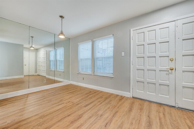 foyer entrance with light hardwood / wood-style floors