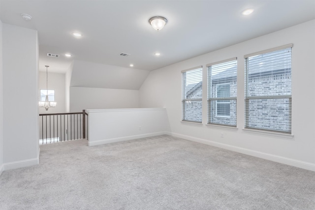 bonus room featuring vaulted ceiling, light colored carpet, and a chandelier