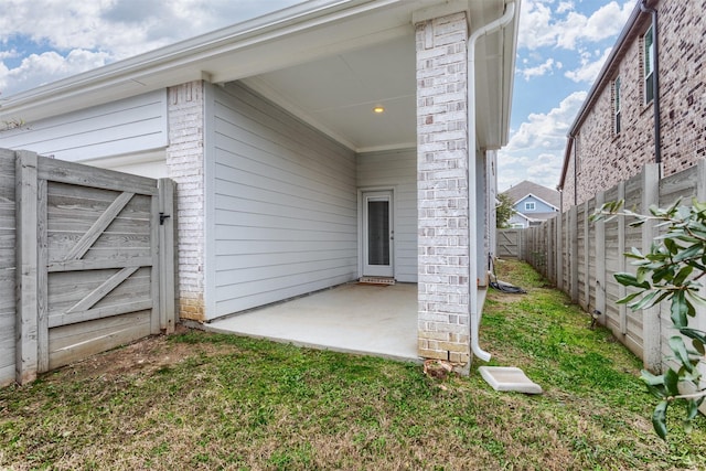 doorway to property featuring a lawn and a patio area