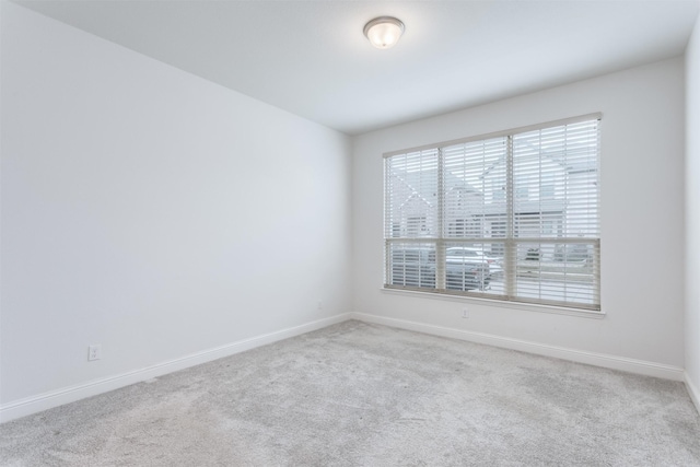 unfurnished room featuring light carpet