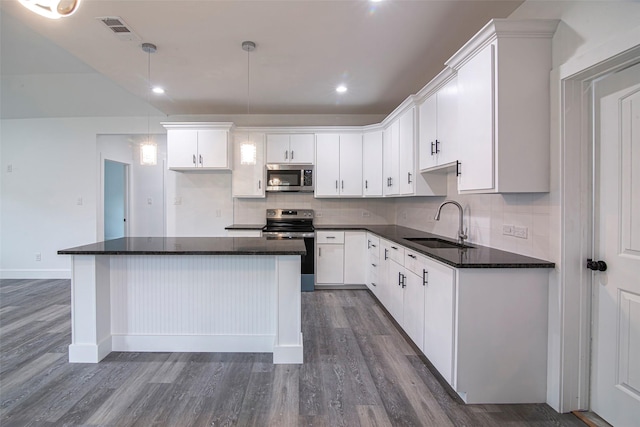 kitchen with pendant lighting, sink, white cabinetry, and stainless steel appliances