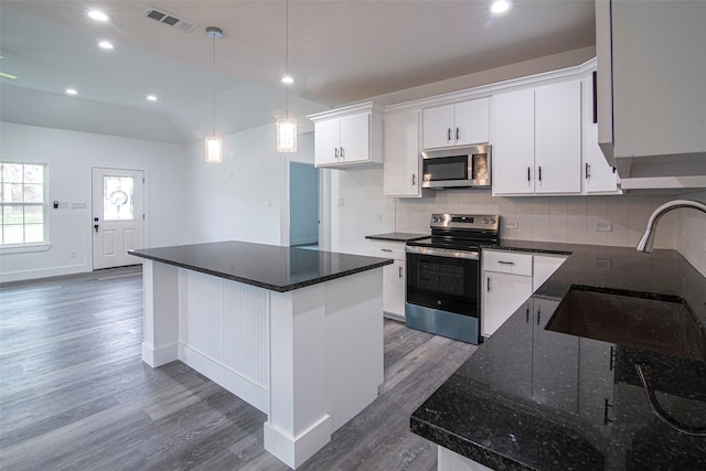 kitchen featuring dark wood-type flooring, white cabinetry, a kitchen island, pendant lighting, and stainless steel appliances