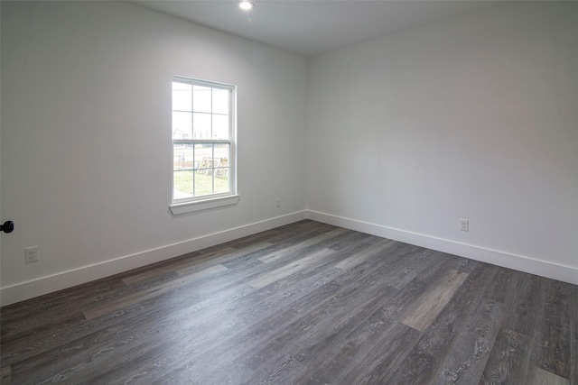 empty room with dark hardwood / wood-style flooring