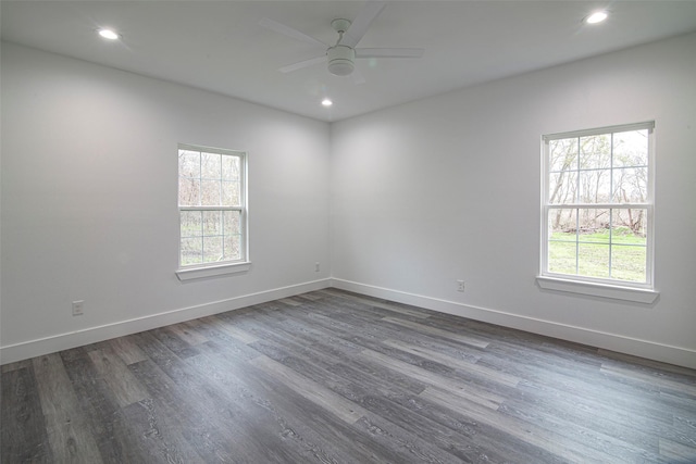 unfurnished room with dark hardwood / wood-style flooring and ceiling fan