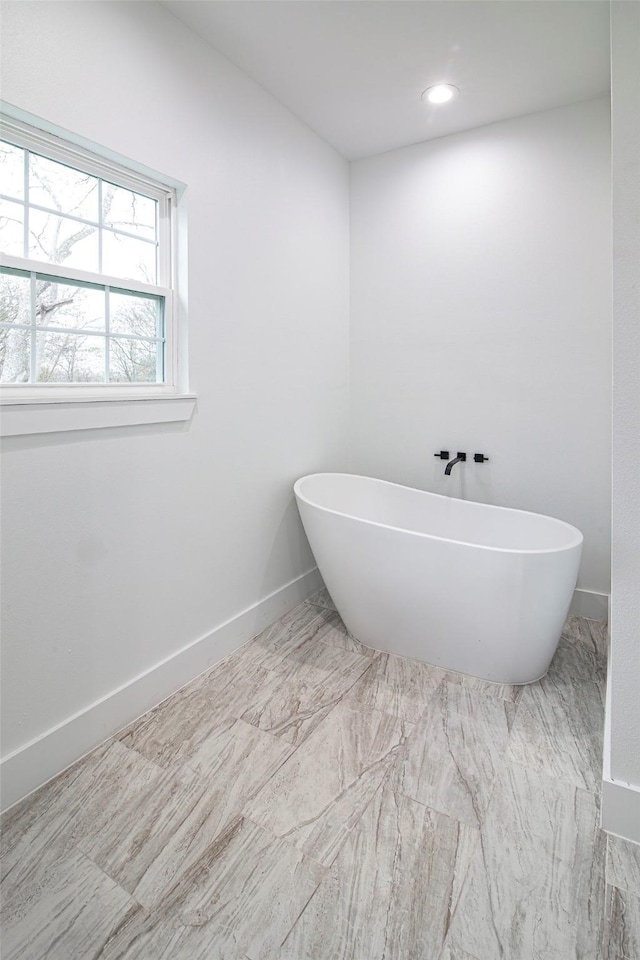 bathroom featuring a tub to relax in