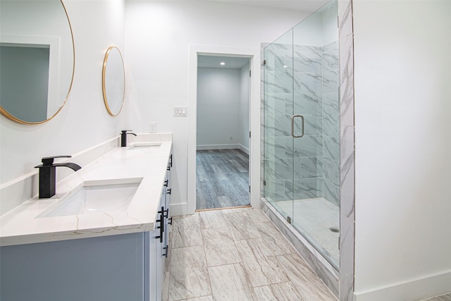 bathroom featuring vanity and a shower with shower door