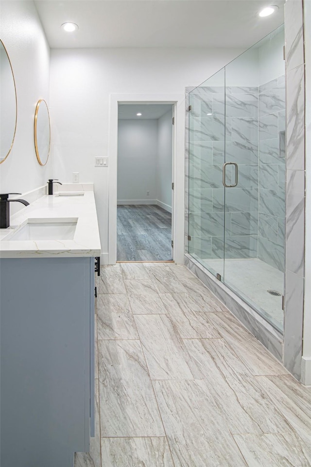 bathroom featuring vanity and a shower with shower door