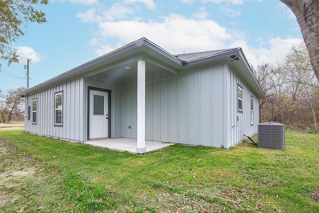 back of property with a patio, cooling unit, and a lawn