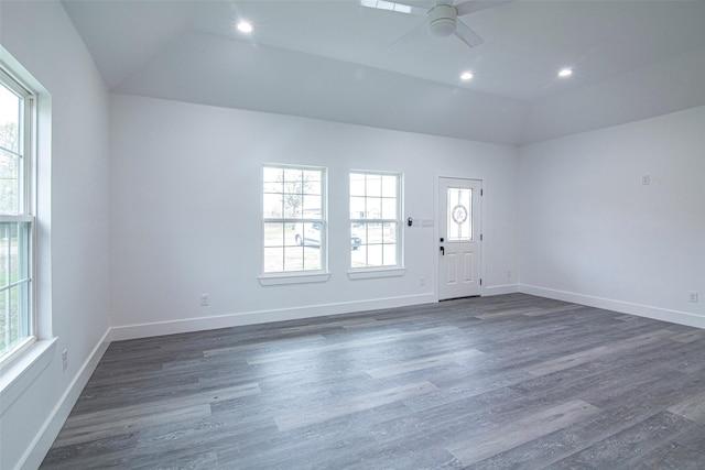 spare room featuring ceiling fan, dark hardwood / wood-style floors, and vaulted ceiling