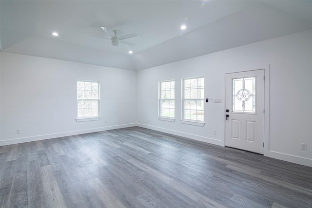 foyer entrance with ceiling fan, lofted ceiling, and dark hardwood / wood-style flooring