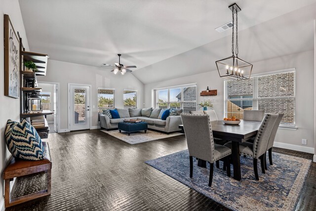 dining space featuring lofted ceiling and ceiling fan with notable chandelier